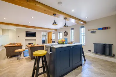 a kitchen with a blue island in a room at Ivy Cottage in Silverdale