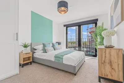a bedroom with a bed and a large window at The Vintara Suite - Central - 2Bed - Cozy Stay in Liverpool
