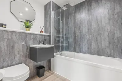 a bathroom with a toilet and a sink and a bath tub at The Vintara Suite - Central - 2Bed - Cozy Stay in Liverpool