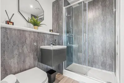 a bathroom with a shower and a toilet and a sink at The Vintara Suite - Central - 2Bed - Cozy Stay in Liverpool