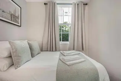 a bedroom with a white bed with a window at GuestReady - Stylish getaway in Liverpool in Liverpool