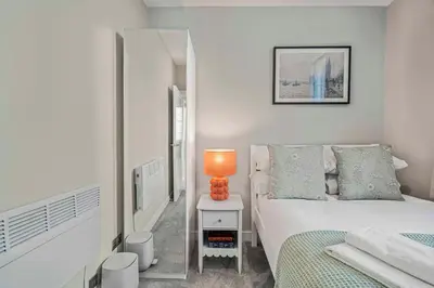 a bedroom with a bed and a lamp on a table at GuestReady - Stylish getaway in Liverpool in Liverpool