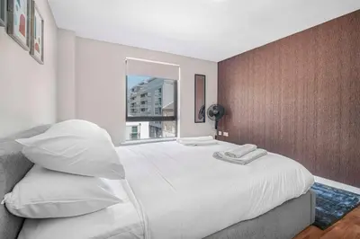 a bedroom with a large white bed with a window at GuestReady - Modern stay in Liverpool city centre in Liverpool