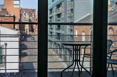 a view of a balcony with a table and chairs at GuestReady - Modern stay in Liverpool city centre in Liverpool