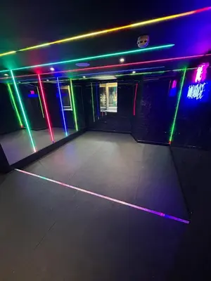 an empty room with neon lights on the wall at New - The Fun House Blackpool - Private nightclub in Blackpool