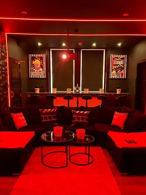 a red room with a couch and a table at New - The Fun House Blackpool - Private nightclub in Blackpool