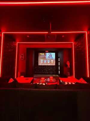 a red room with a tv and red lights at New - The Fun House Blackpool - Private nightclub in Blackpool