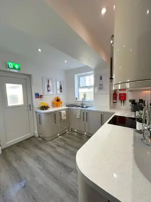 a large kitchen with white cabinets and a counter top at New - The Fun House Blackpool - Private nightclub in Blackpool