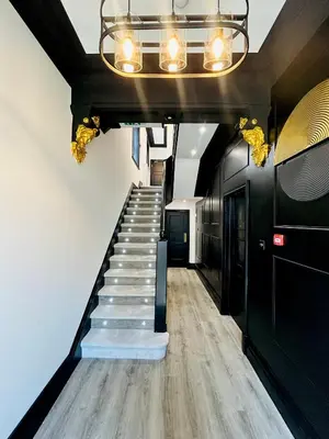 a hallway with a staircase and a chandelier at New - The Fun House Blackpool - Private nightclub in Blackpool