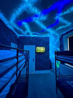 a room with two bunk beds and a blue ceiling at New - The Fun House Blackpool - Private nightclub in Blackpool