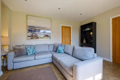 a living room with a blue couch in a room at The Bank House in Silverdale