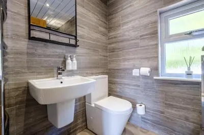 a bathroom with a white toilet and a sink at The Bank House in Silverdale