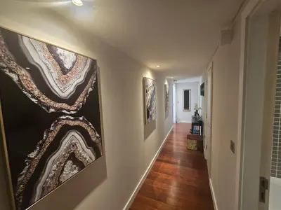 a hallway with paintings on the walls of a home at Ventro Apartments LIVERPOOL in Liverpool