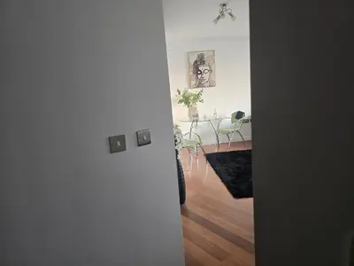 a hallway with a table and a dining room at Ventro Apartments LIVERPOOL in Liverpool