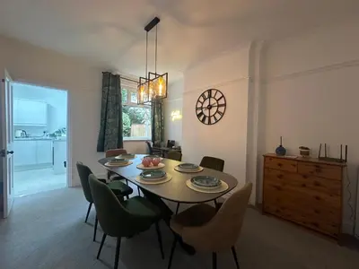 a dining room with a table and chairs at Your Home in Southport! in Southport
