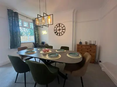 a dining room with a table and chairs at Your Home in Southport! in Southport