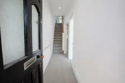 a hallway of a house with a door and stairs at Your Home in Southport! in Southport