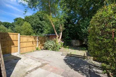 a backyard with a wooden fence and a patio at Your Home in Southport! in Southport