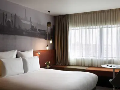a hotel room with a large bed and a window at Pullman Liverpool in Liverpool