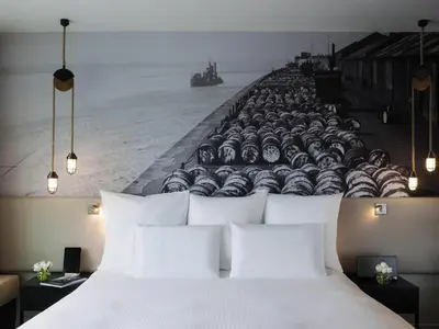a bedroom with a large white bed with a wall of watermelons at Pullman Liverpool in Liverpool