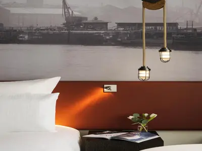 a hotel room with a bed and a view of a river at Pullman Liverpool in Liverpool