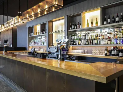 a bar with a lot of bottles of alcohol at Pullman Liverpool in Liverpool
