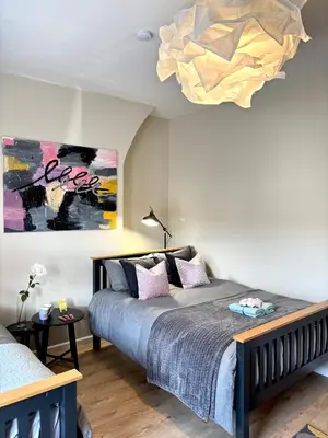 a bedroom with a bed and a chandelier at Modern Art House - serviced accomodation in Liverpool