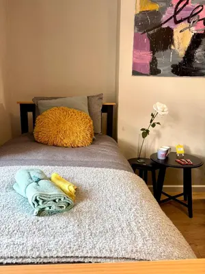 a bed with two pillows on it in a room at Modern Art House - serviced accomodation in Liverpool