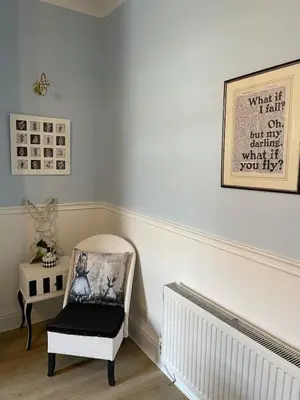 a room with a chair and a picture on the wall at Alices House in Fleetwood