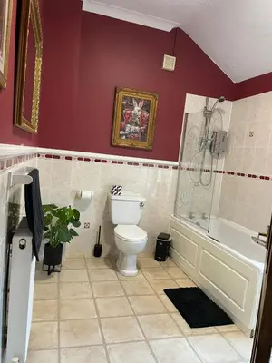 a bathroom with a toilet and a tub and a sink at Alices House in Fleetwood