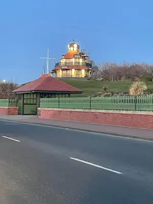 a building on the side of a road next to a street at Alices House in Fleetwood
