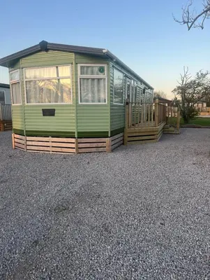 a green house sitting on top of a gravel lot at Seaside Getaway - Lytham Road in Warton
