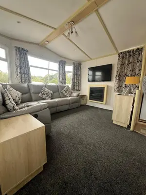 a living room with a couch and a tv at Seaside Getaway - Lytham Road in Warton