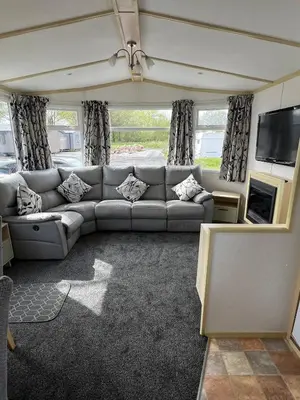 a living room with a couch and a tv at Seaside Getaway - Lytham Road in Warton