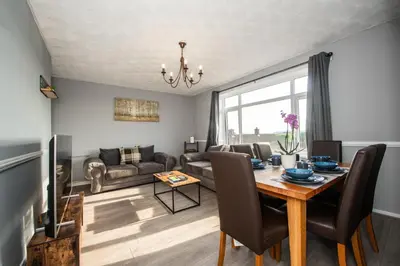 a living room with a table and a couch at Swindon Home in Liverpool