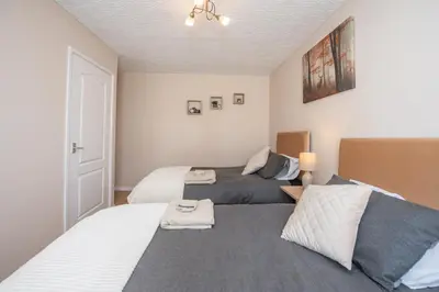 a bedroom with two beds with towels on them at Swindon Home in Liverpool