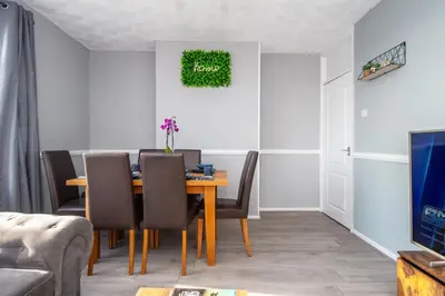 a dining room with a table and chairs at Swindon Home in Liverpool