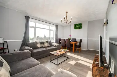 a living room with a couch and a table at Swindon Home in Liverpool