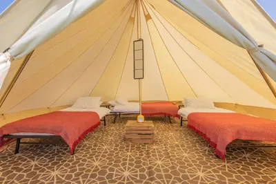 a marquee with three beds in a tent at Nine Yards Bell Tents - Lytham in Lytham St Annes