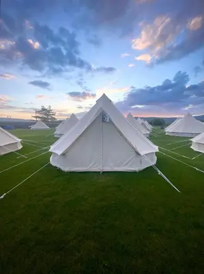 a group of white tents in a field at Nine Yards Bell Tents - Lytham in Lytham St Annes