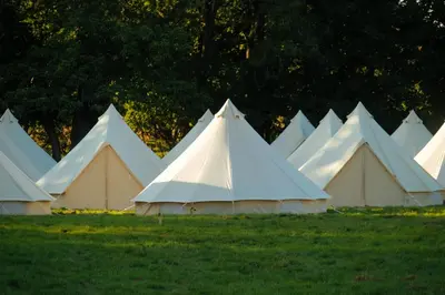 a group of white tents in a field at Nine Yards Bell Tents - Lytham in Lytham St Annes