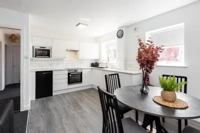 a kitchen and dining room with a table and chairs at Waterfront 2 Bed Apartment - Free Parking & Wi-Fi in Preston