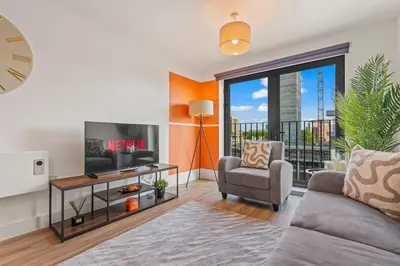a living room with a couch and a tv at Elegance Suite 2Bed 2BR Contractors Central in Liverpool