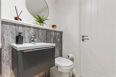 a bathroom with a sink and a toilet and a mirror at Elegance Suite 2Bed 2BR Contractors Central in Liverpool