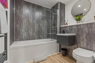 a bathroom with a tub and a toilet and a sink at Elegance Suite 2Bed 2BR Contractors Central in Liverpool