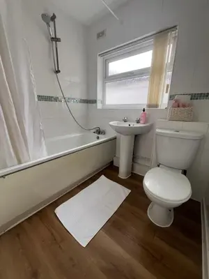 a white bathroom with a toilet and a sink at Liverpool Rose House Stylish 3 Bed Near Anfield and Goodison Park in Liverpool
