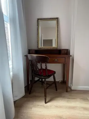 a wooden desk with a chair and a mirror at Liverpool Rose House Stylish 3 Bed Near Anfield and Goodison Park in Liverpool