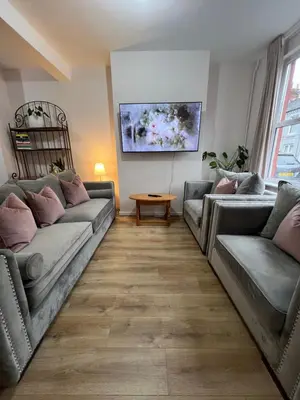 a living room with two couches and a table at Liverpool Rose House Stylish 3 Bed Near Anfield and Goodison Park in Liverpool