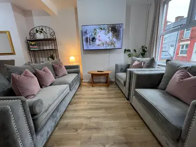 a living room with two couches and a table at Liverpool Rose House Stylish 3 Bed Near Anfield and Goodison Park in Liverpool