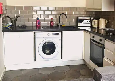 a kitchen with a washing machine in a kitchen at The Vault Liverpool City Centre sleeps 4 in Liverpool